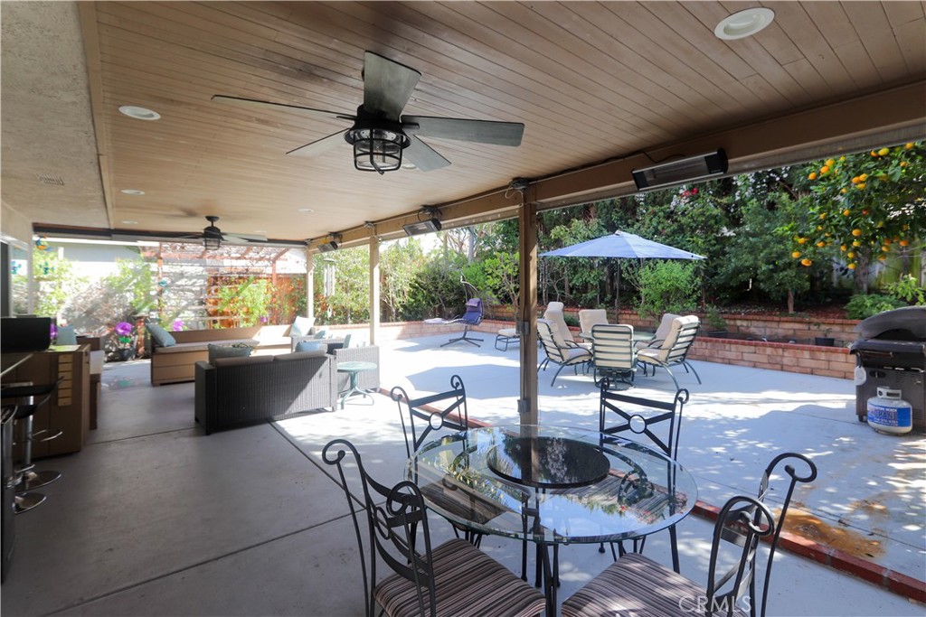 8 Sandpiper Irvine, CA 92604 - Photo 34 of 45 a view of a patio with dining table and chairs under an umbrella with a patio