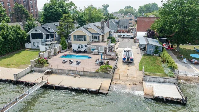 an aerial view of a house with a garden and lake view