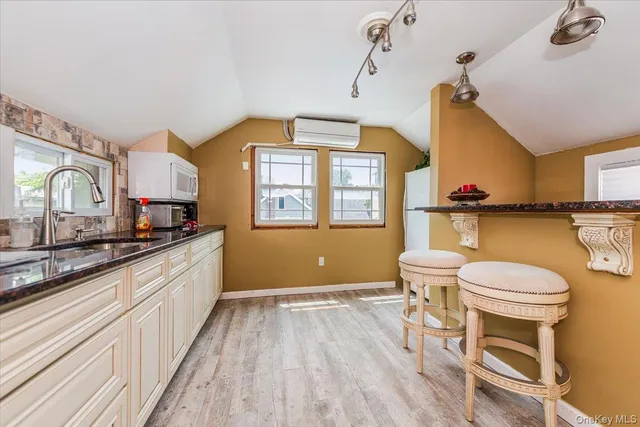 a kitchen with a sink and a wooden floor