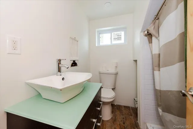 a bathroom with a sink toilet and shower