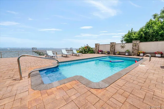 swimming pool view with a outdoor seating space