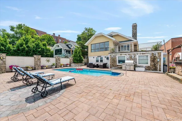a view of a house with swimming pool and sitting area