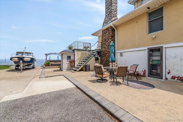 a view of a patio with a dining table and chairs