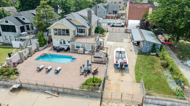 an aerial view of a house with swimming pool garden and patio