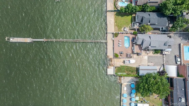 an aerial view of a house with swimming pool and patio