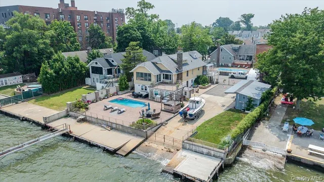 an aerial view of a house with swimming pool and furniture