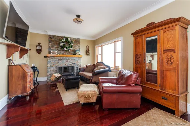 a living room with furniture a flat screen tv and a fireplace