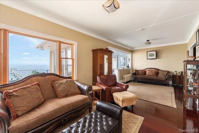 a living room with furniture ceiling fan and a window