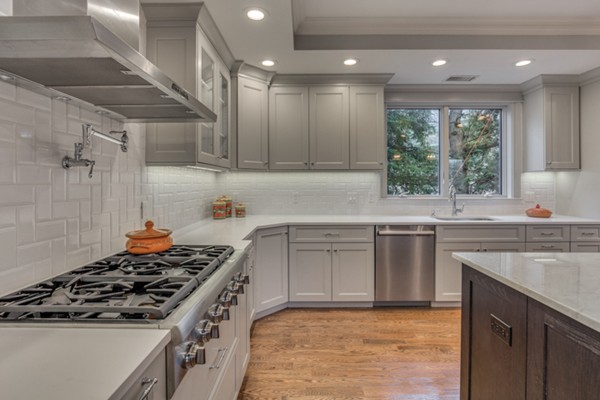 39 Lorena Road Winchester, MA 01890 - Photo 12 of 30 a kitchen with kitchen island granite countertop a sink stove and cabinets