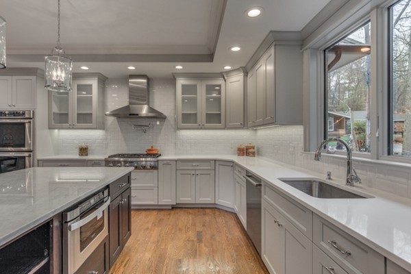 39 Lorena Road Winchester, MA 01890 - Photo 14 of 30 a kitchen with a sink stove and cabinets