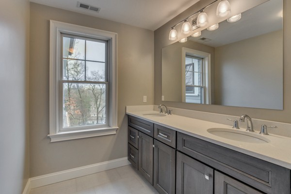 39 Lorena Road Winchester, MA 01890 - Photo 26 of 30 a bathroom with a double vanity sink and a mirror