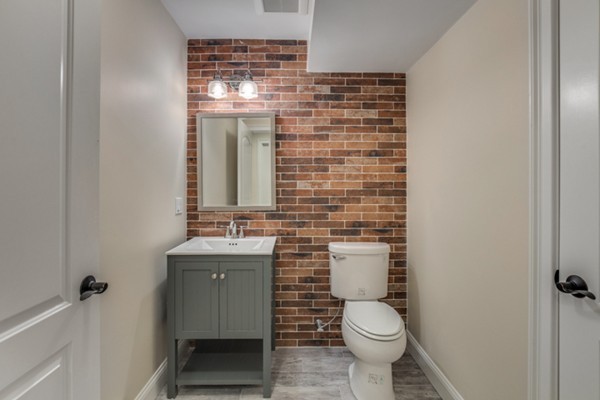 39 Lorena Road Winchester, MA 01890 - Photo 28 of 30 a bathroom with a toilet sink and mirror