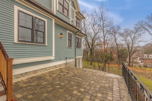 39 Lorena Road Winchester, MA 01890 - Photo 30 of 30 a porch with a bench next to a yard