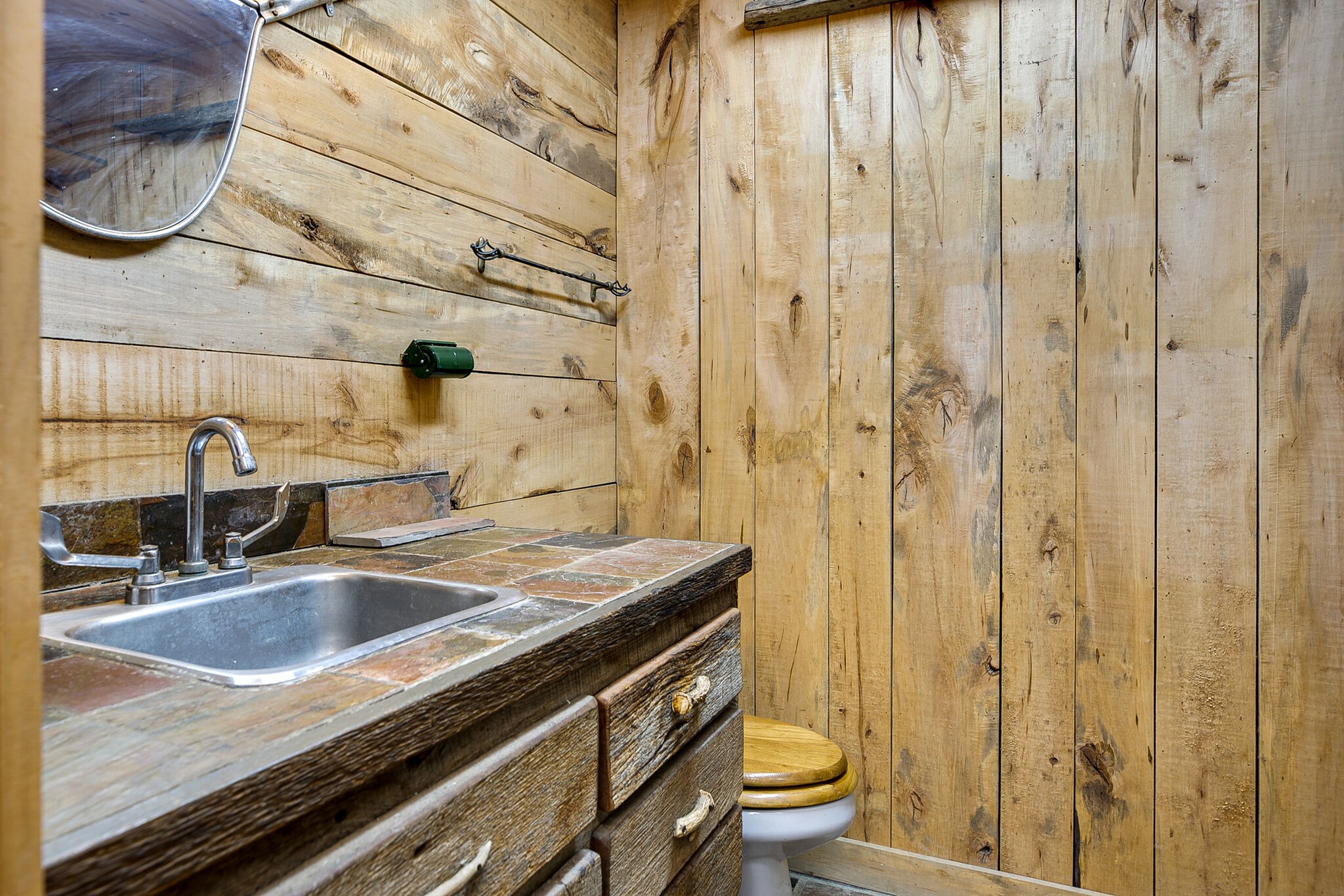 660 Rocky Top Road Sparta, TN 38583 - Photo 35 of 39 a bathroom with a granite countertop sink a toilet and shower