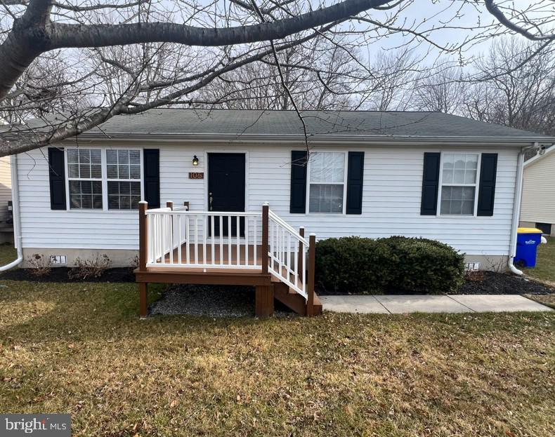 a view of a house with a yard and a porch