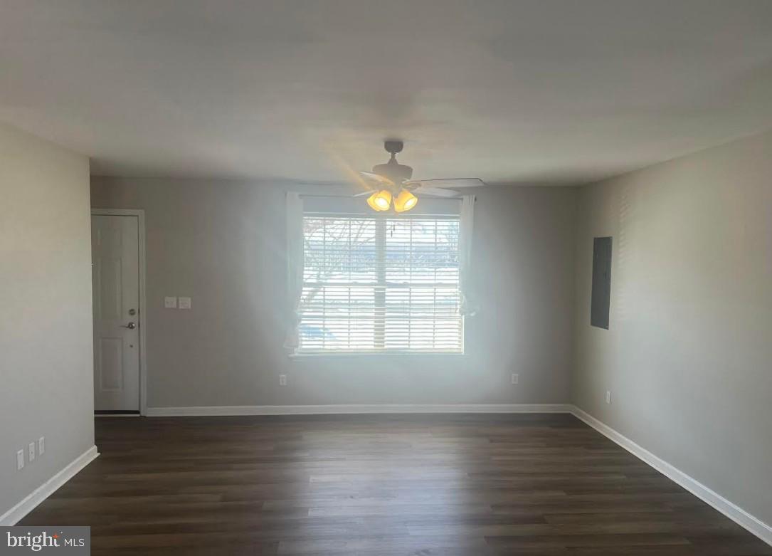 105 Gravel Run Road Grasonville, MD 21638 - Photo 2 of 12 an empty room with wooden floor and windows