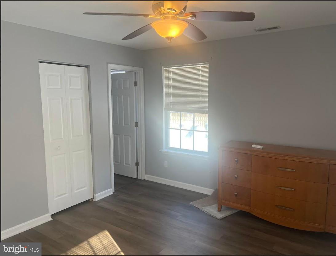 105 Gravel Run Road Grasonville, MD 21638 - Photo 6 of 12 an empty room with wooden floor and windows