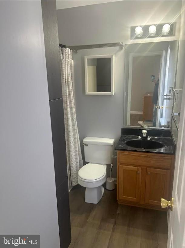 105 Gravel Run Road Grasonville, MD 21638 - Photo 7 of 12 a bathroom with a granite countertop toilet and a sink