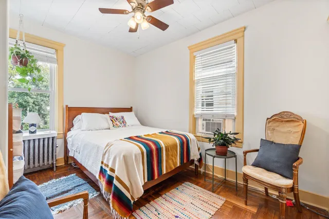 a bedroom with a bed a couch and dresser