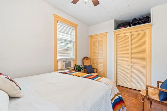 a bedroom with a bed and a window