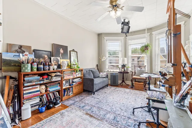 a living room with furniture a chandelier and a large window