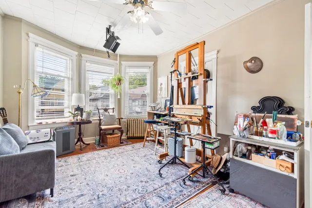 a living room filled with furniture hardwood floor and a chandelier