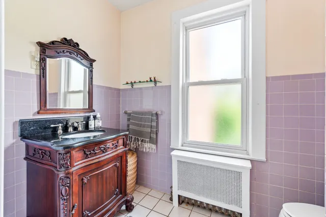 a kitchen with a stove a sink and a window