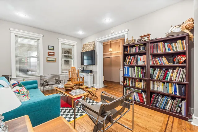 a living room with furniture a book shelf and a book shelf