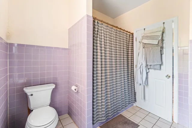 a bathroom with a toilet and shower