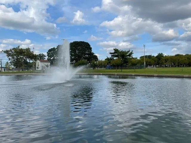 a view of a lake with houses in the background