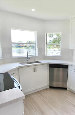 a kitchen with a sink and a large window