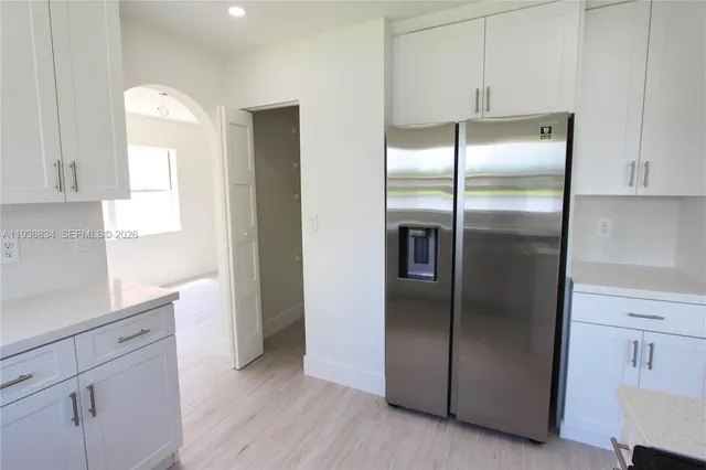 a kitchen with metallic refrigerator freezer and a dishwasher
