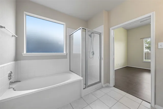 a bathroom with a bathtub and a shower