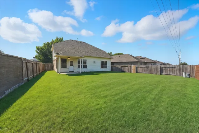 a view of a house with a yard and sitting area
