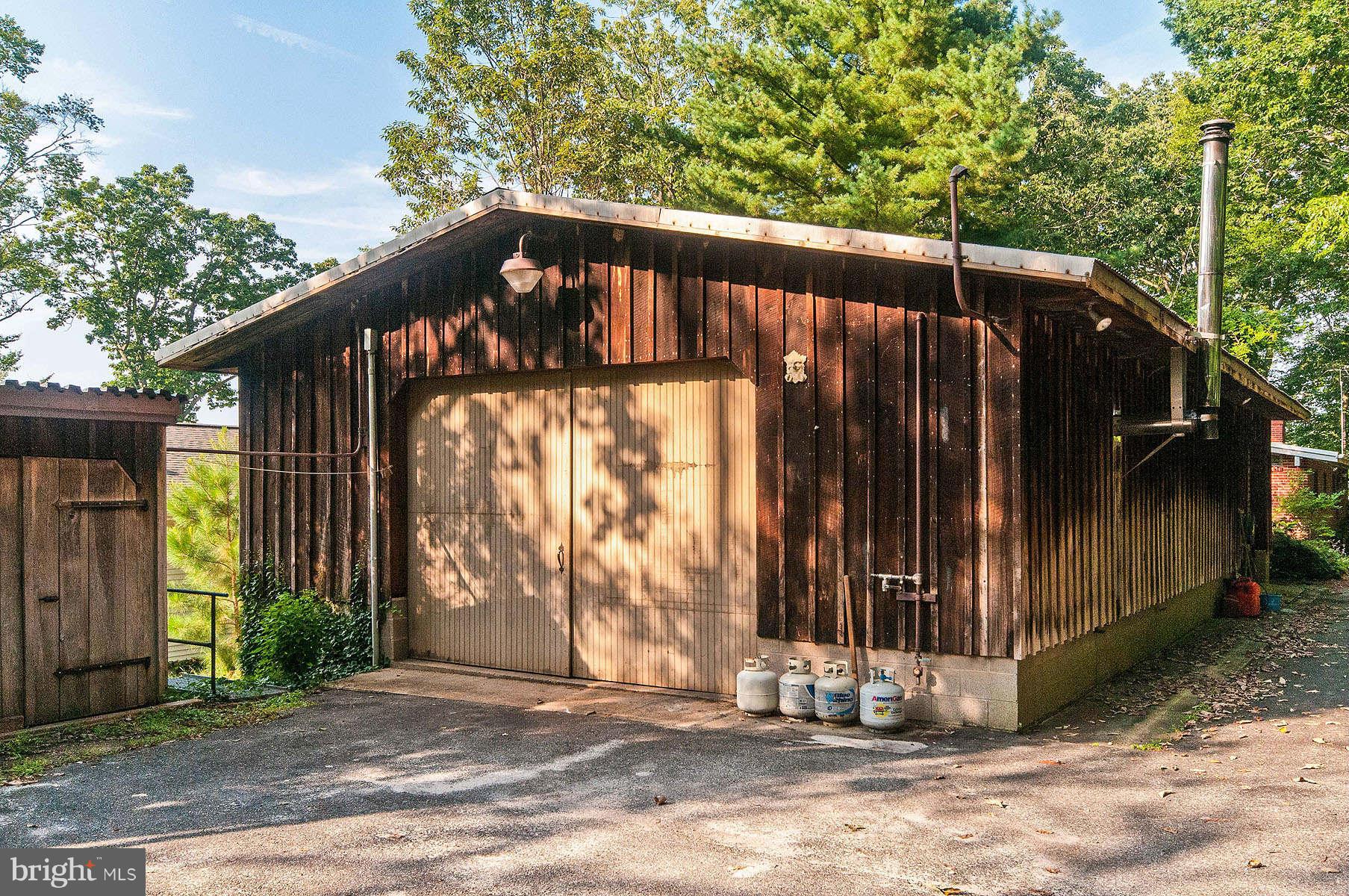 24 Woodmour Manor Road Earleville, MD 21919 - Photo 29 of 30 Cedar Garage with Workshop and Wood Stove