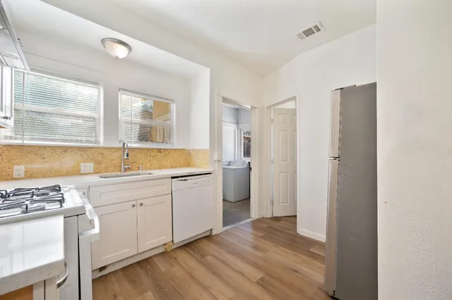 a kitchen with a stove top oven sink and cabinets