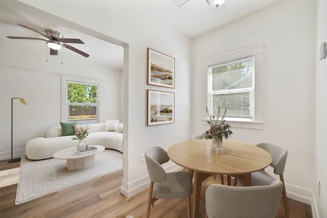 a view of a house with backyard and sitting area