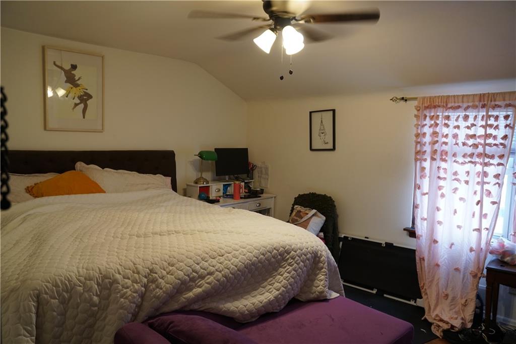 2003 Lafayette Street Pittsburgh, PA 15218 - Photo 7 of 12 a bedroom with a bed and a chandelier
