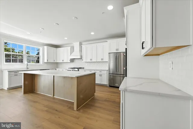 a large kitchen with a sink and large window