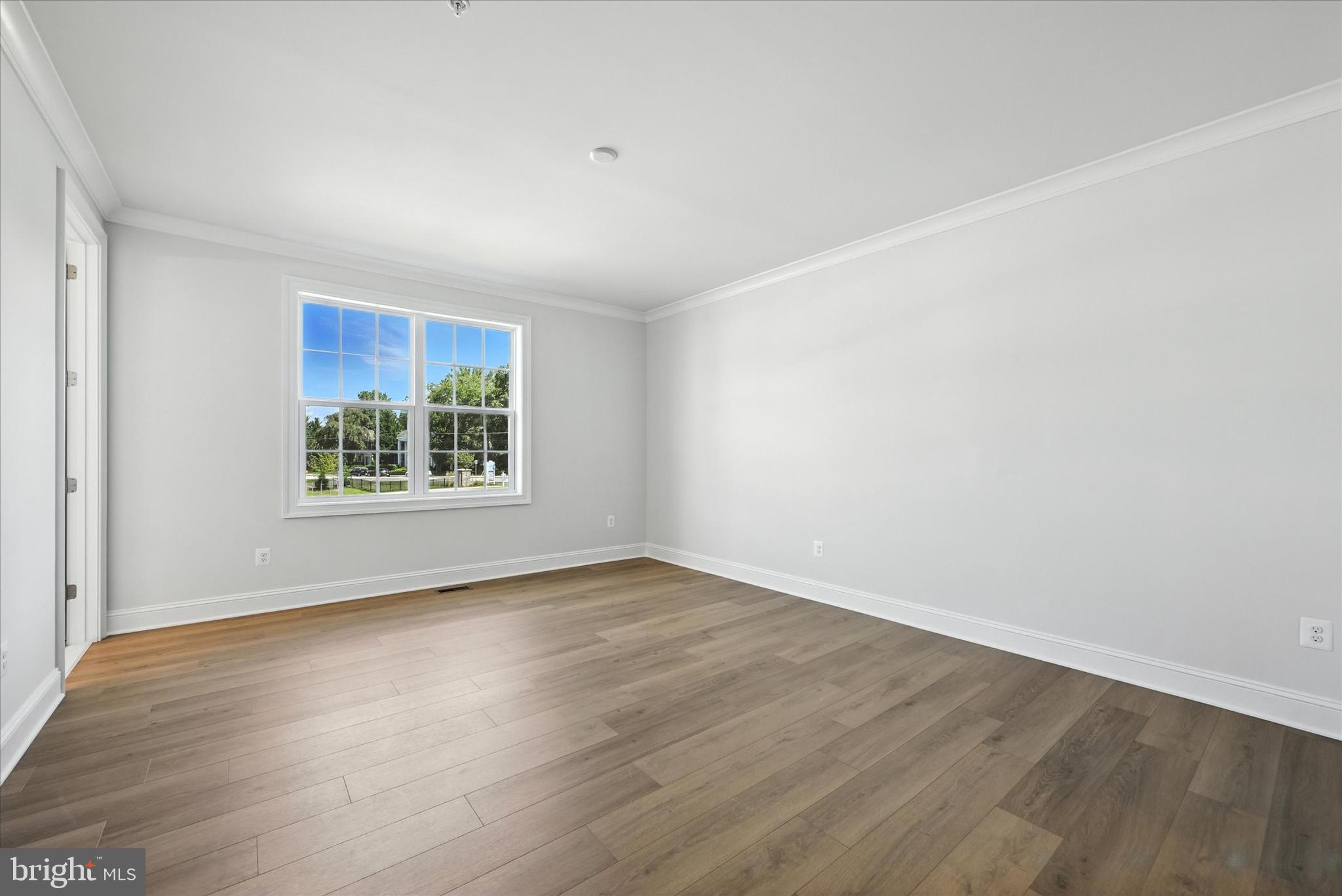 106 Villabrook Way Baltimore, MD 21212 - Photo 24 of 60 an empty room with wooden floor and windows