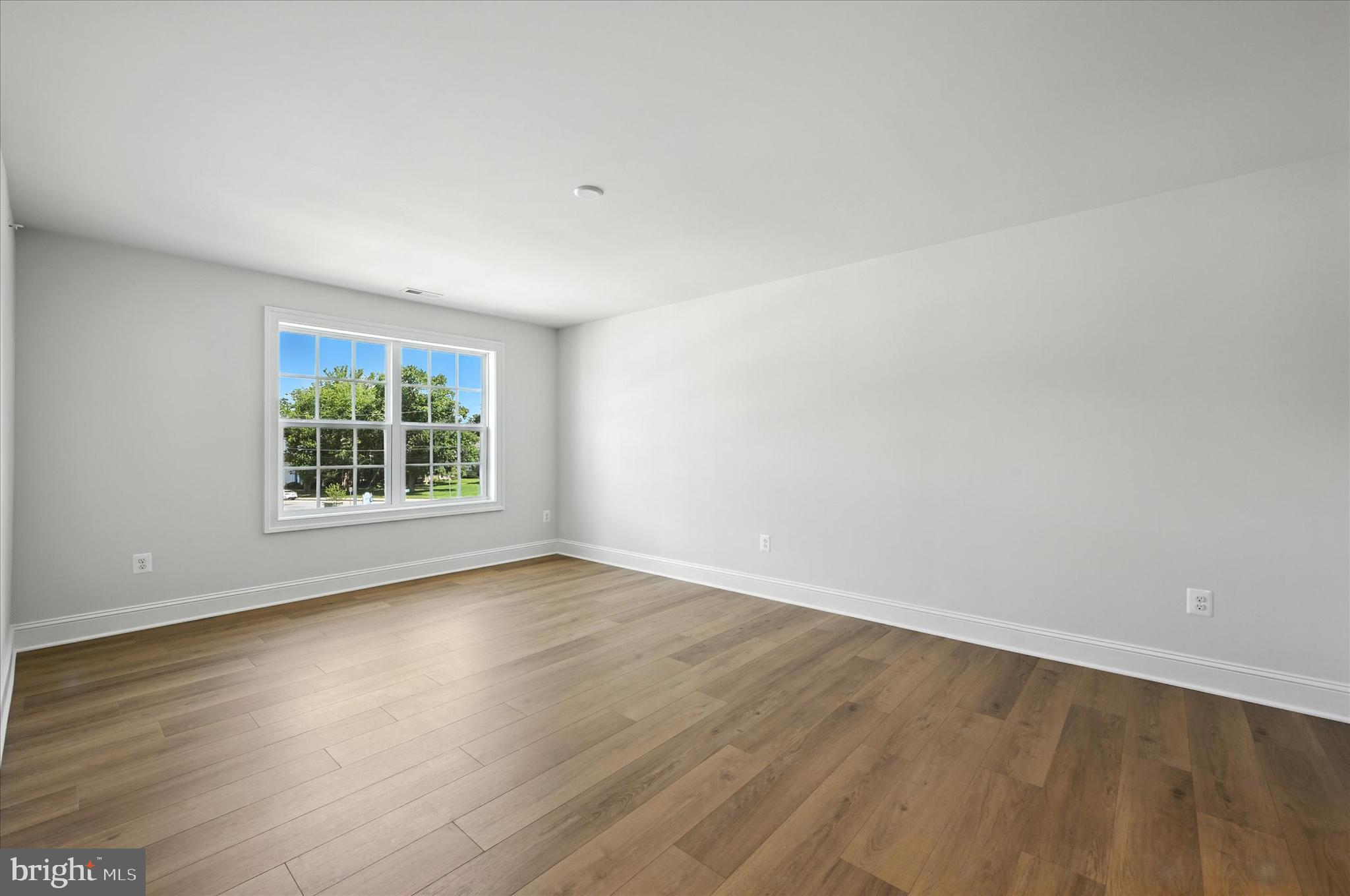 106 Villabrook Way Baltimore, MD 21212 - Photo 28 of 60 a view of an empty room with wooden floor and a window