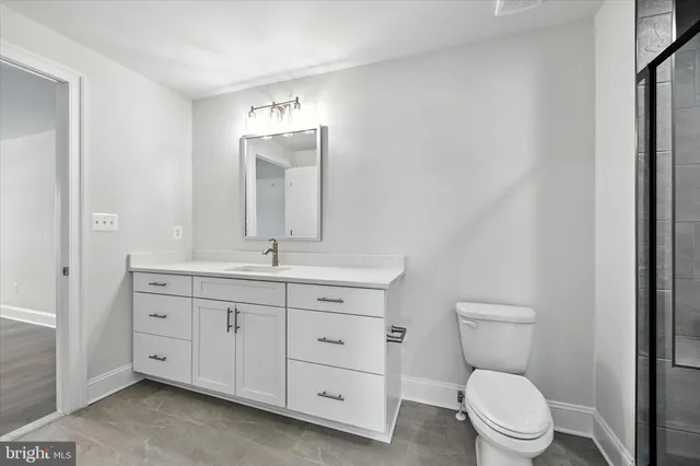 a bathroom with a toilet a sink and mirror