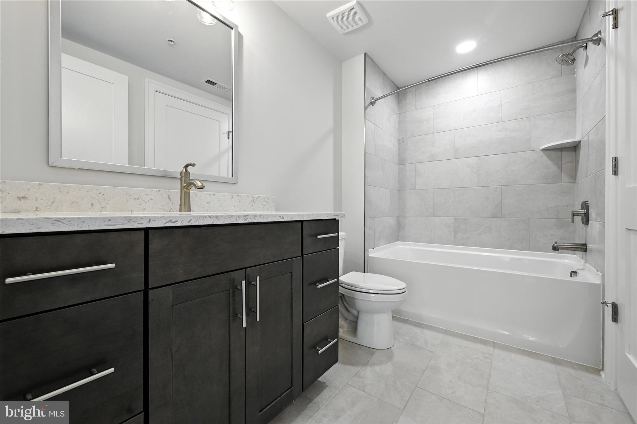 106 Villabrook Way Baltimore, MD 21212 - Photo 39 of 60 a bathroom with a bathtub shower sink vanity mirror and toilet