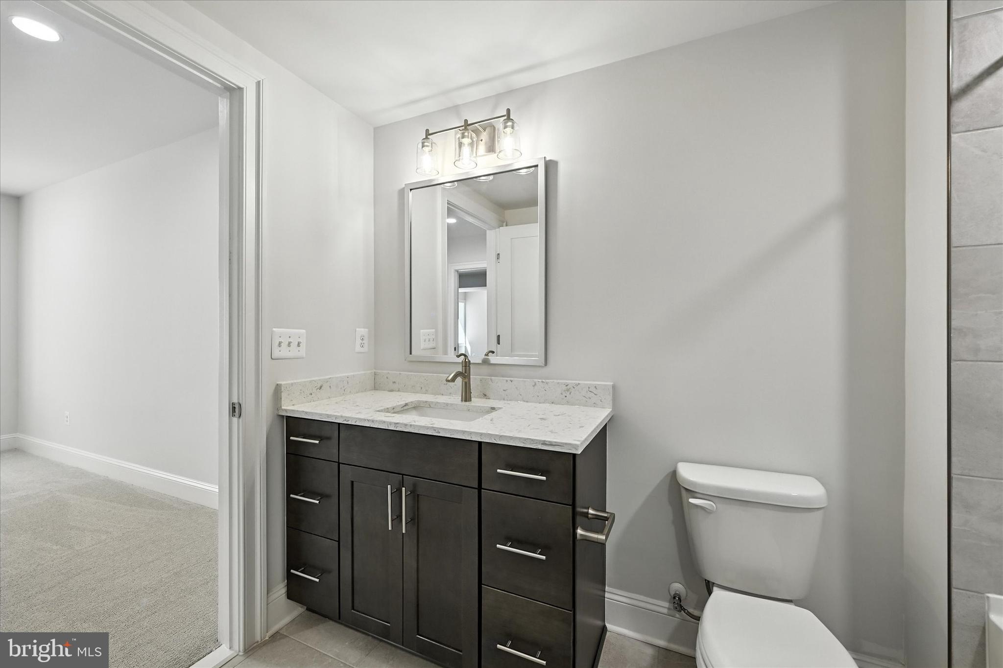 106 Villabrook Way Baltimore, MD 21212 - Photo 40 of 60 a bathroom with a toilet a sink and mirror