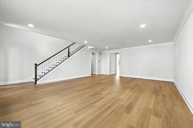 a view of an empty room with wooden floor