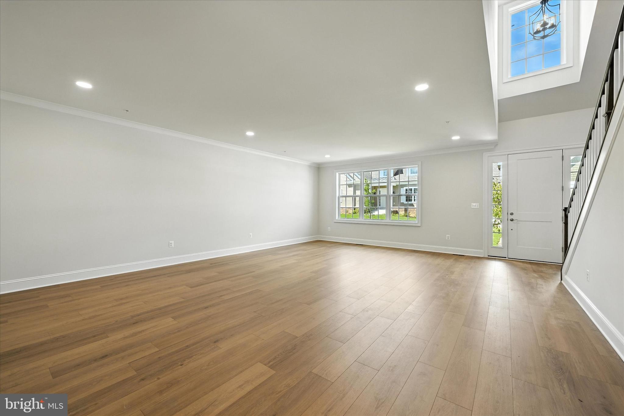106 Villabrook Way Baltimore, MD 21212 - Photo 7 of 60 an empty room with wooden floor and windows