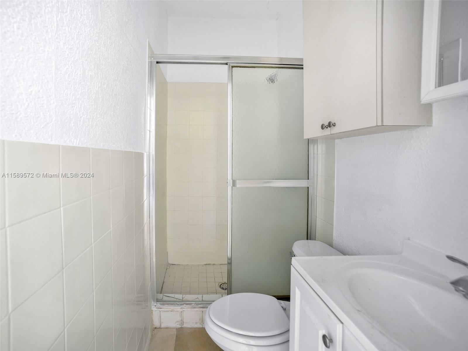 265 East 7th Street Hialeah, FL 33010 - Photo 15 of 28 a bathroom with a sink a toilet and shower