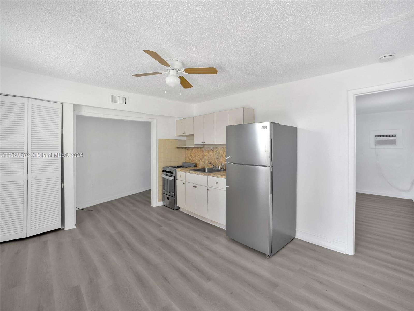 265 East 7th Street Hialeah, FL 33010 - Photo 16 of 28 a view of a kitchen with a sink and wooden floor