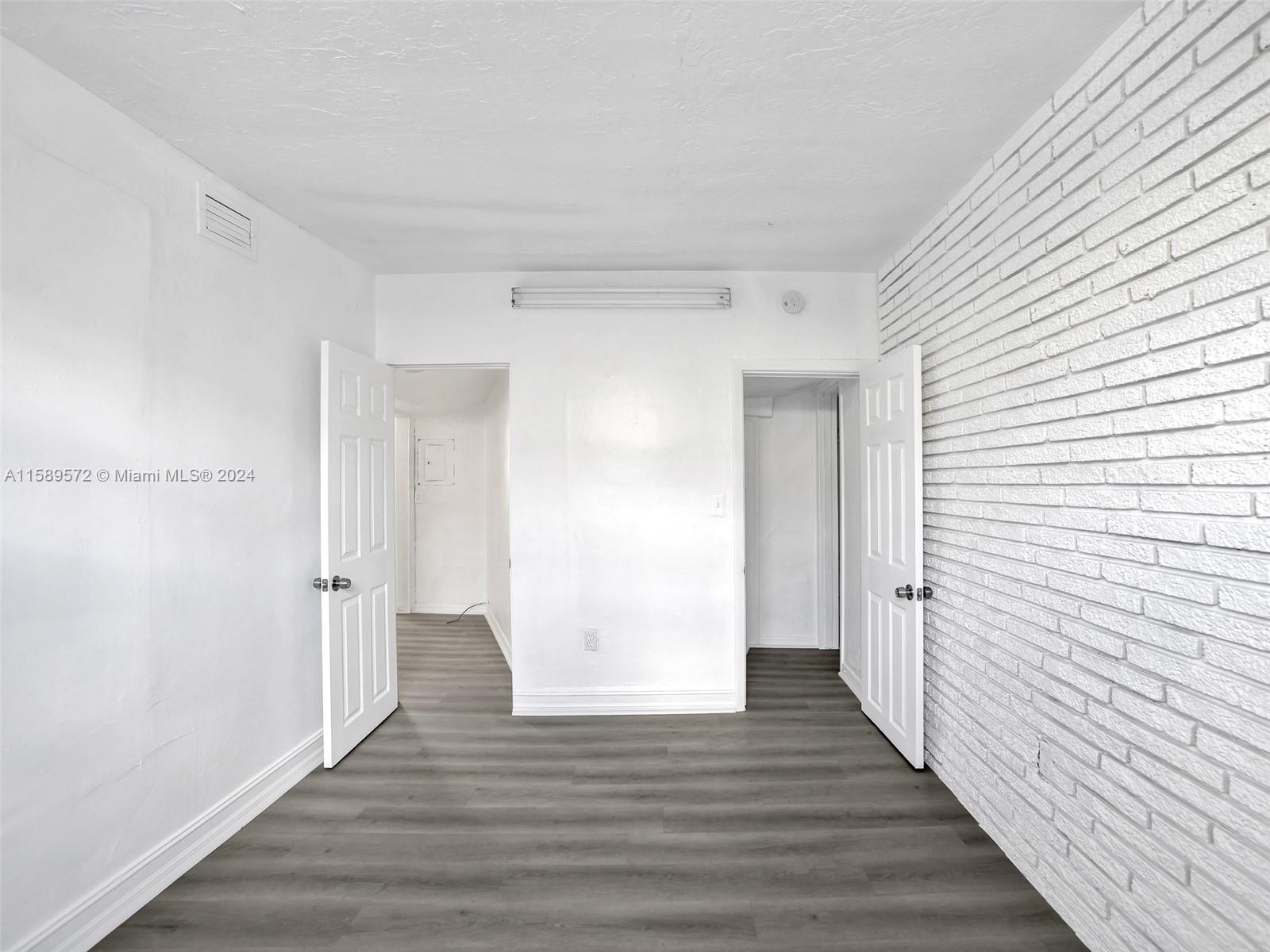 265 East 7th Street Hialeah, FL 33010 - Photo 20 of 28 a view of an empty room with wooden floor