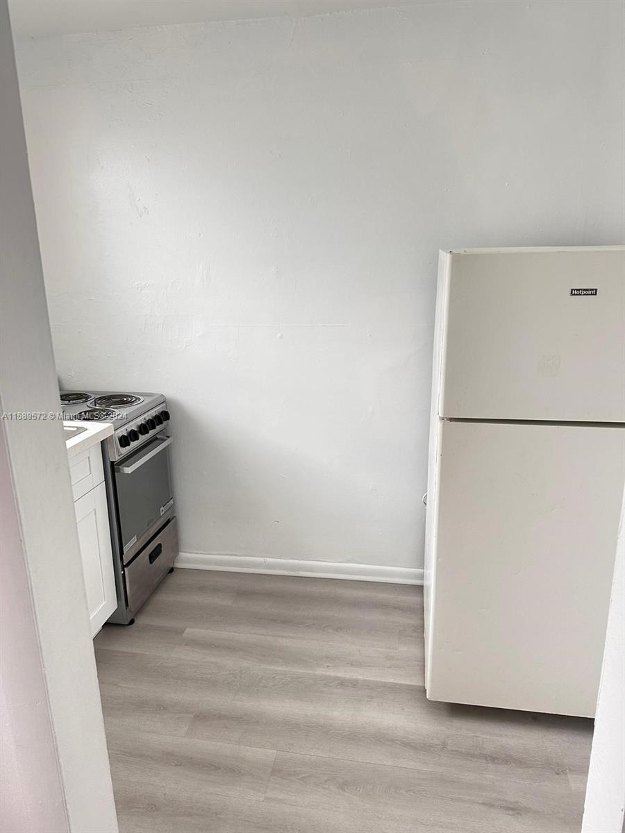 265 East 7th Street Hialeah, FL 33010 - Photo 23 of 28 a view of a refrigerator in kitchen and an empty room